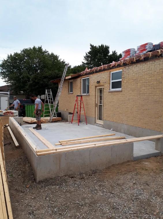 Construction site showing foundation work for home addition and expansion